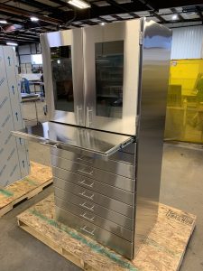 Custom stainless steel cabinet with pull out stainless writing surface.